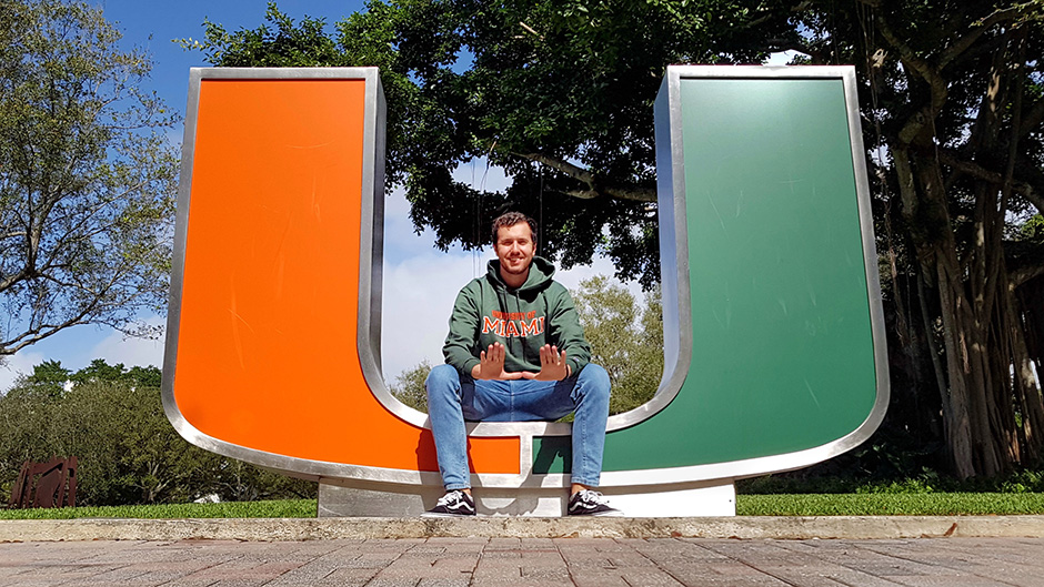 student poses for a photo on campus