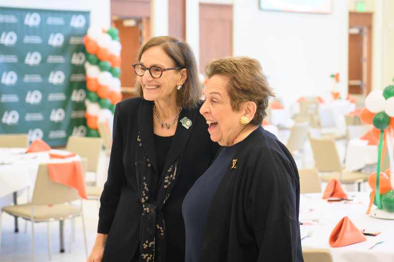 Dean Rebecca M. Fox and former University of Miami President Donna Shalala greet attendees at the 40th anniversary breakfast for the Osher Lifelong Learning Institute.