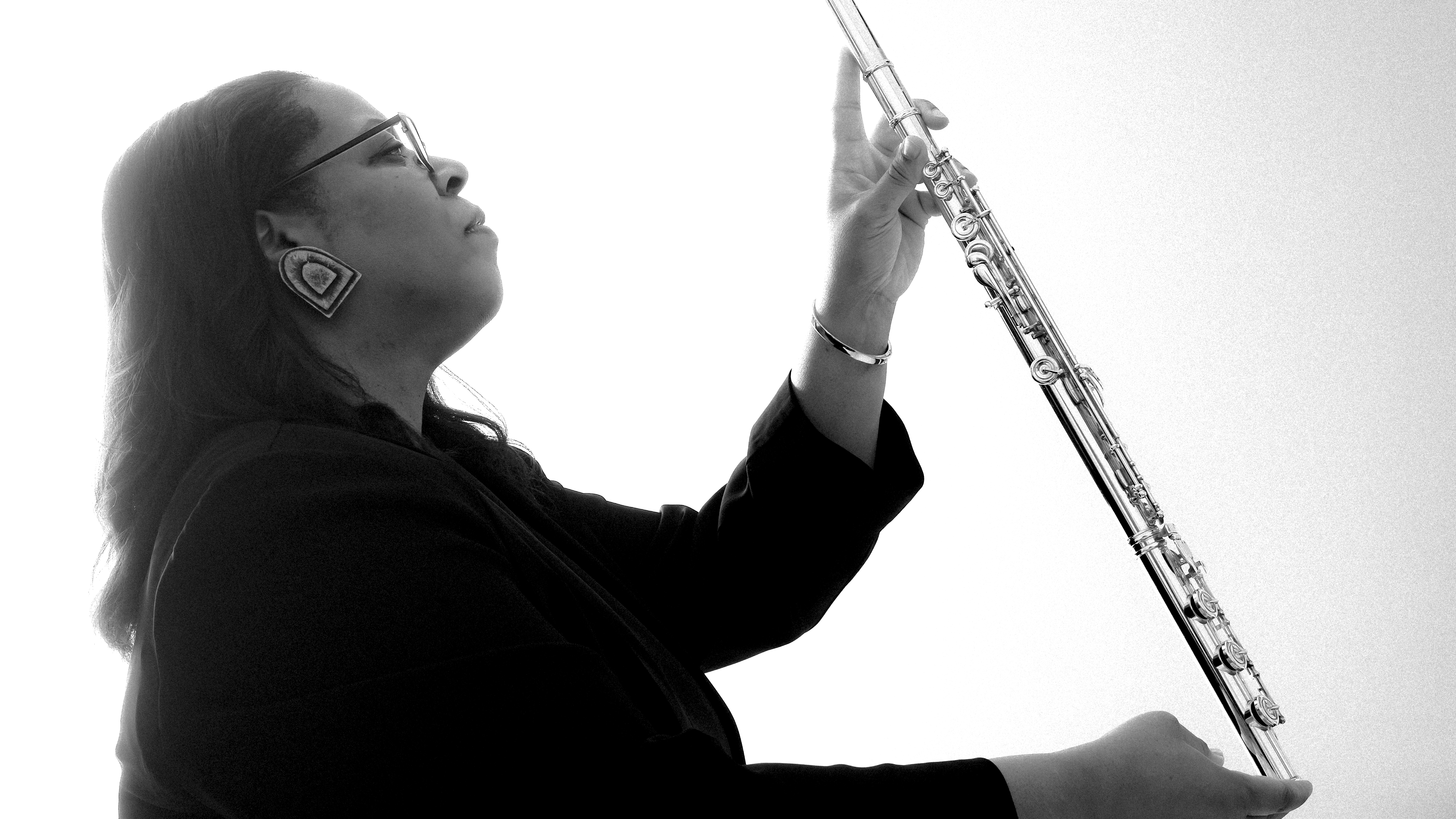 valerie coleman hold a flute and looks up
