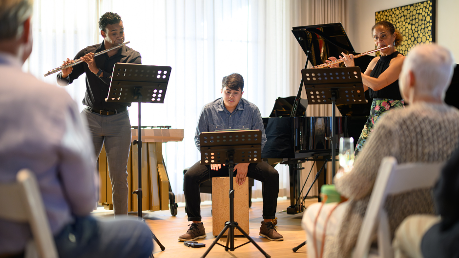 Students Rafael Mendez (left) and Shane Roderick (center) performing with professor Jennifer Grim (right) at Jeffrey Miller's home. Photo by Bob McClenahan/courtesy of the Frost School of Music.