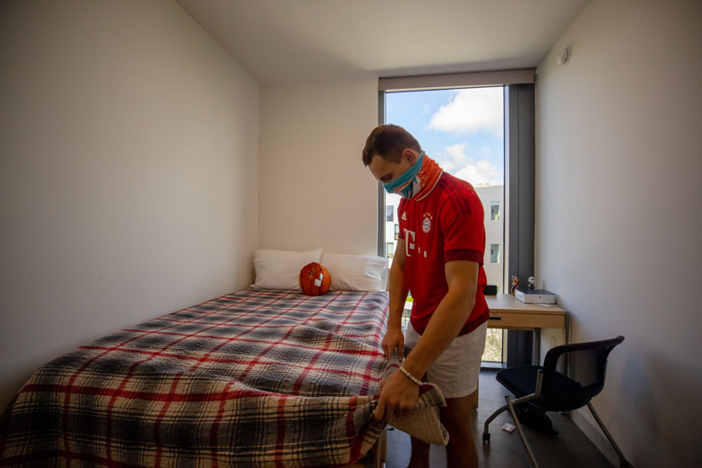 Jimmy Dickey puts the finishing touches on his bedroom as he moves into Lakeside Village on Thursday, August 13, 2020.