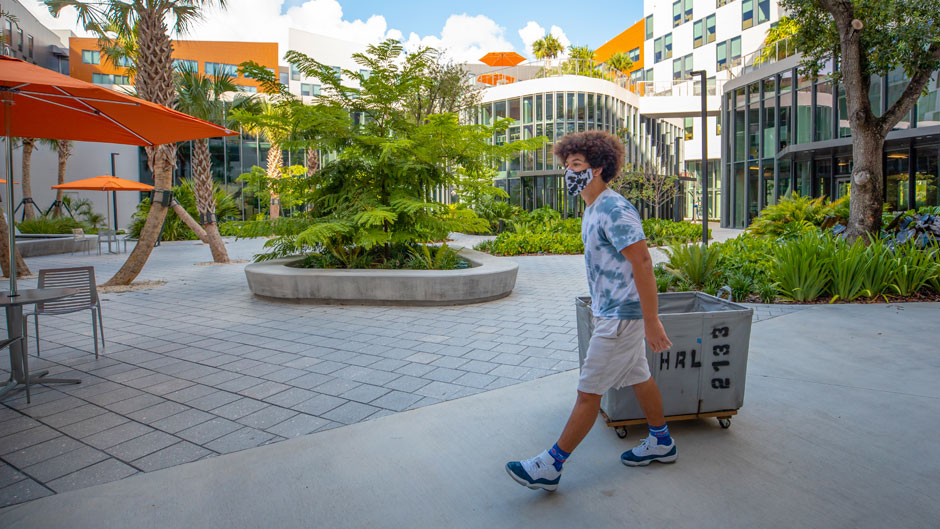 A student pulls a cart as he moves into Lakeside Village on Thursday, August 13, 2020.