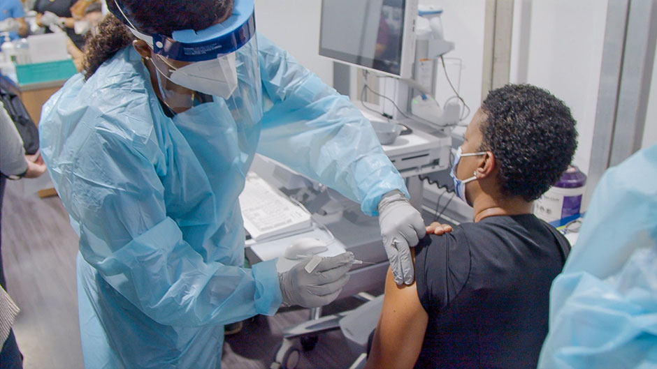 Kimar Estes, a nursing leader at UHealth, received her first vaccine shot on Tuesday. Photo: Evan Garcia/University of Miami