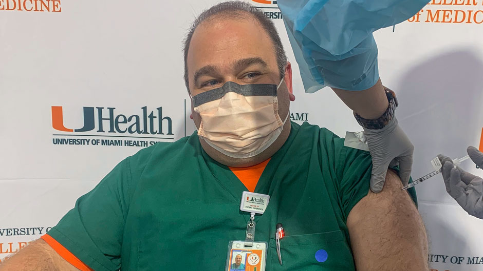 Joe Falise, a nursing leader at UHealth, received the first COVID-19 vaccine shot administered by the University of Miami’s Medical Campus on Tuesday afternoon. 