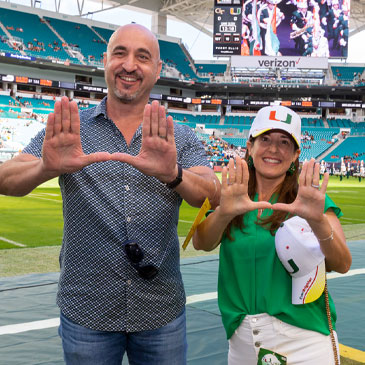 Andy Unanue and wife on football sidelines