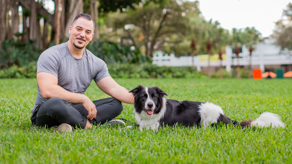 Brian Galea with his dog Dash on the Coral Gables Campus. Photo: TJ Lievonen/University of Miami