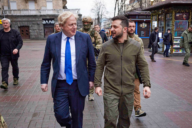 In this image provided by the Ukrainian Presidential Press Office, Ukrainian President Volodymyr Zelenskyy, center right, and Britain's Prime Minister Boris Johnson, center left, walk during their meeting in downtown Kyiv, Ukraine, Saturday, April 9, 2022. (Ukrainian Presidential Press Office via AP)