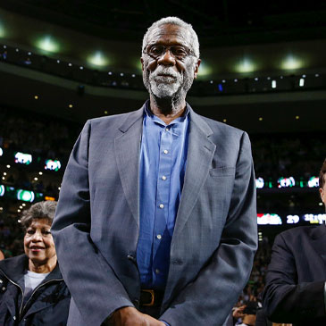 FILE - Boston Celtics legend Bill Russell stands court side during a tribute in his honor in the second quarter of an NBA basketball game against the Milwaukee Bucks in Boston, Nov. 1, 2013. The NBA great Bill Russell has died at age 88. His family said on social media that Russell died on Sunday, July 31, 2022. Russell anchored a Boston Celtics dynasty that won 11 titles in 13 years. (AP Photo/Michael Dwyer, file)