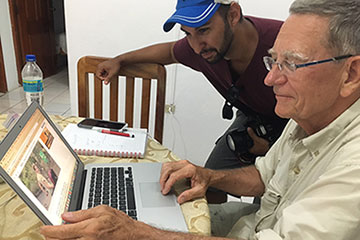 Photographer Thomas Rodriguez, standing, and writer Joseph P. Treaster