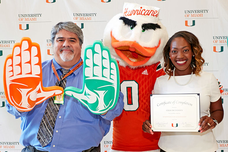 Isamel Pimienta and Celia McFadden pose with Sebastian the Ibis at the Essentials of Leadership graduation celebration