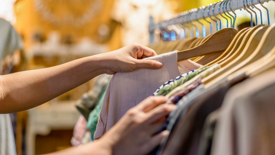 Retail shopper peruses a clothing rack
