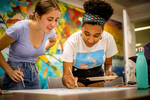 Members of the ECO Agency work on posters that they hope will add to the visual art of the Global Climate Strike movement