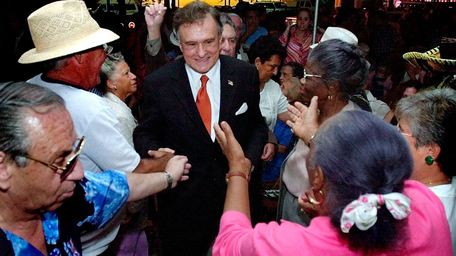 Maurice Ferre, center, candidate for Miami mayor, is greeted by supporters during a rally Friday Oct. 26, 2001 in the Little Havana district in Miami. Nearly 100 supporters showed up at the rally braving the rainfall for the opening of Ferre's campaign office. (AP Photo/Tony Gutierrez)
