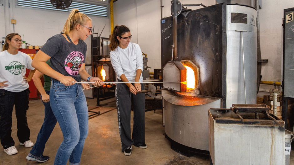 Students in glassblowing class