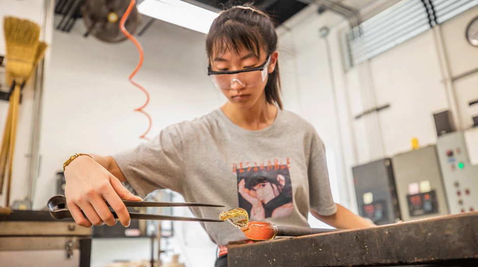 Student working with glass