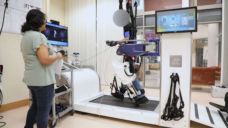 A paralyzed research participant, who was implanted with a brain-machine interface, is using his thoughts to initiate steps while on a robotic walking simulator.
