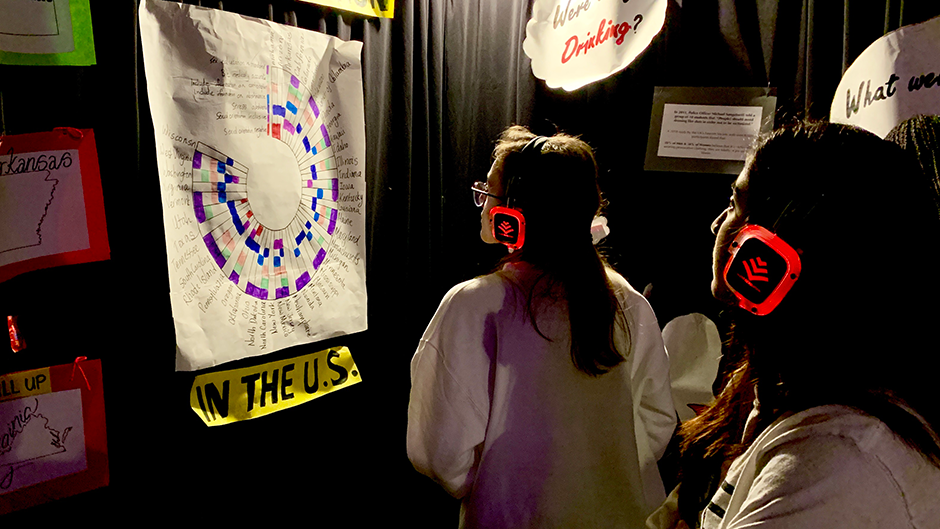 Students listen to a guided tour as they walk through the Tunnel of Oppression to learn more about the exhibits on display.