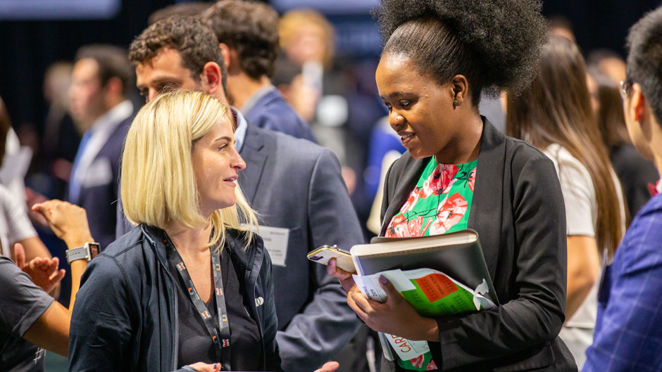 University of Miami student networks during a career fair at the Watsco Center in 2019.