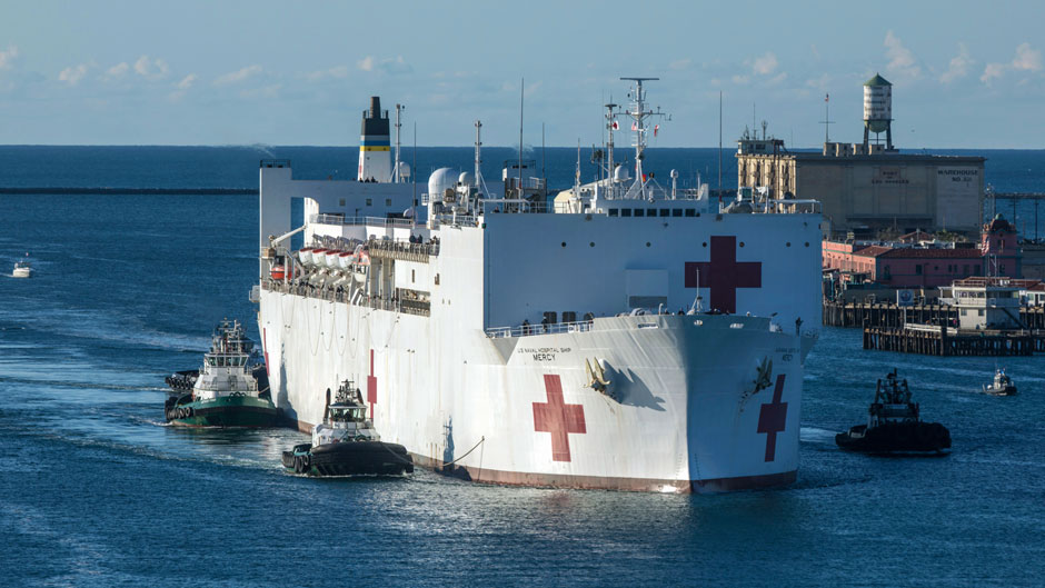 The Military Sealift Command hospital ship USNS Mercy (T-AH 19) arrives in Los Angeles, Calif., Friday, March 27, 2020. Mercy deployed in support of the nation's COVID-19 response efforts, and will serve as a referral hospital for non-COVID-19 patients currently admitted to shore-based hospitals. (Cpl. Alexa Hernandez/U.S. Marine Corps via AP)