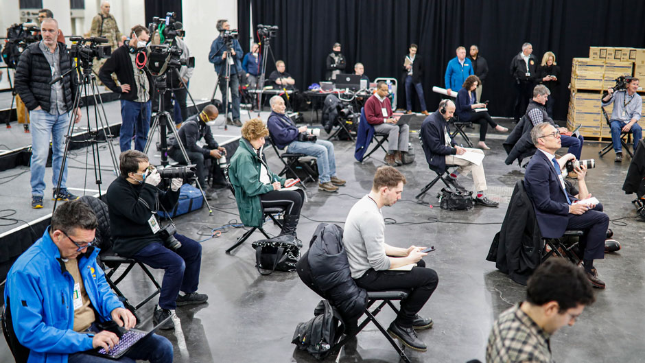 FILE - In this March 24, 2020, file photo journalists practice social distancing during a news conference with New York Gov. Andrew Cuomo at the Jacob Javits Center that will house a temporary hospital in response to the COVID-19 outbreak in New York. (AP Photo/John Minchillo, File)