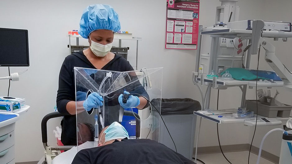 Nichole Crenshaw, assistant professor of clinical and director of the Acute Care Nurse Practitioner Program at the School of Nursing and Health Studies, performing the mock intubation procedure at the Simulation Hospital. 