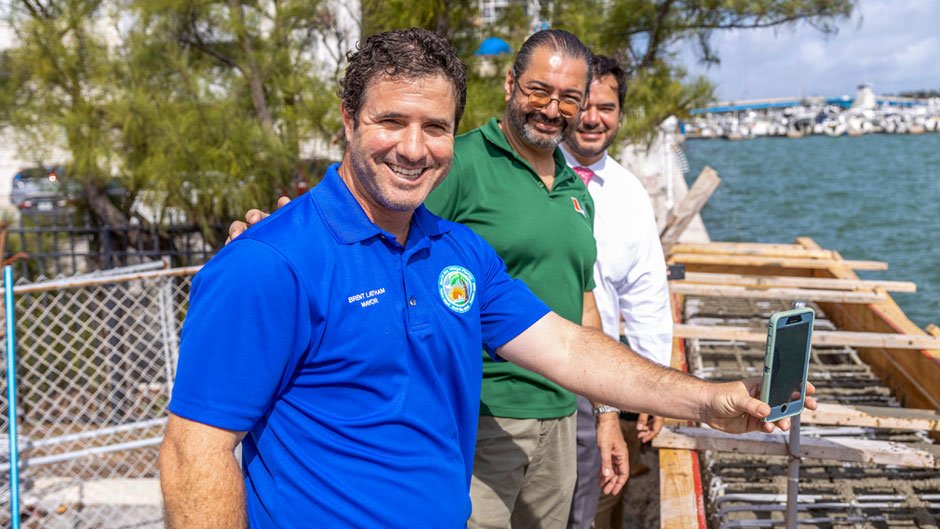 North Bay Village mayor Brent Latham poses for a photo with associate professor Esber Andiroglu and village manager Ralph Rosado in February, when the design of a graduate student in the University's  College of Engineering was used to construct a 50-foot section of seawall in North Bay Village. 