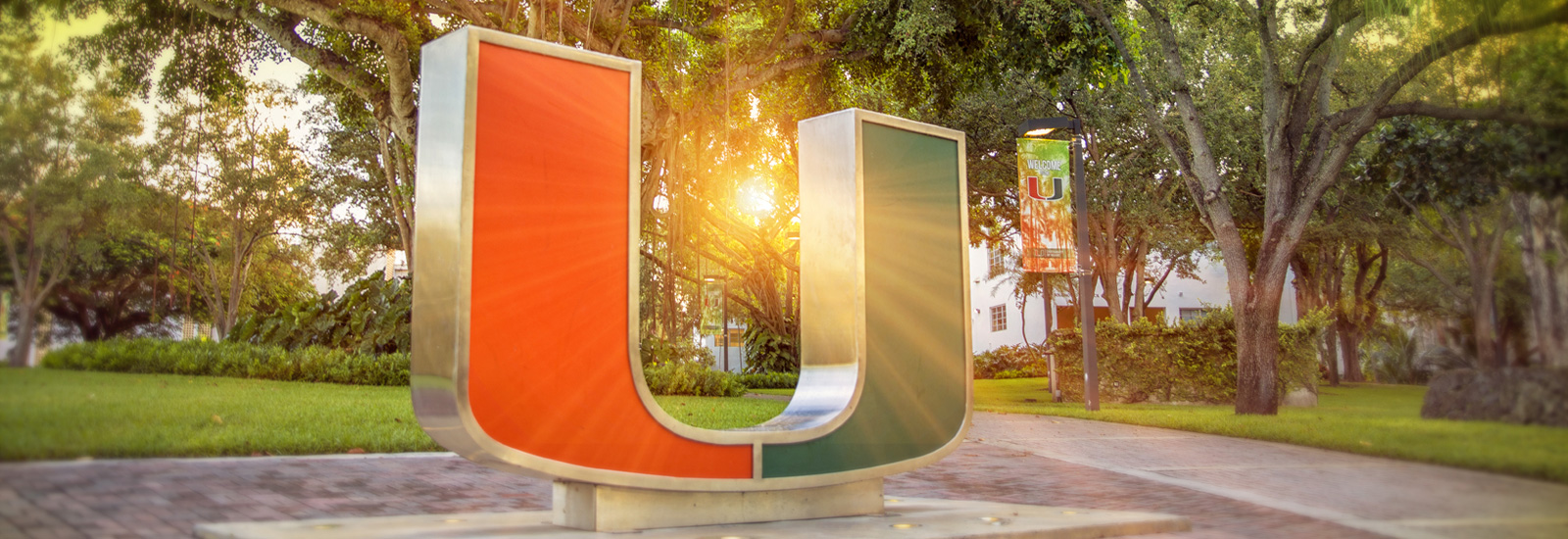 Sun peeks through U statue on Gables Campus