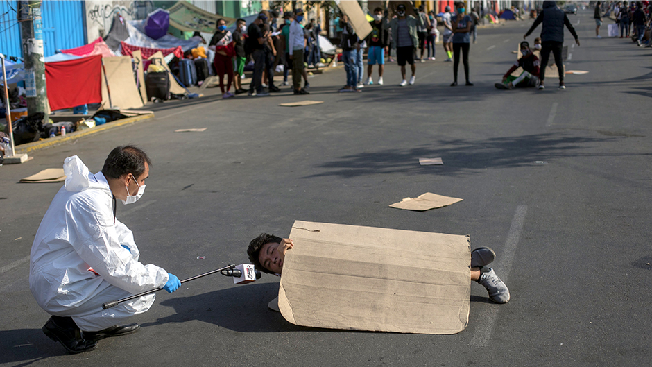 A television journalist interviews 18-year-old Adrian Sanchez as he blocks an avenue in a protest against authorities for not being helped to return to his home province, in Lima, Peru, Thursday, April 30, 2020. Photo: Associated Press
