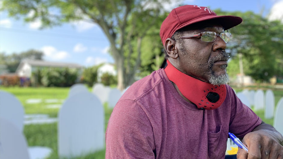 Kurris Presley, seen here visiting Simonhoff Floral Park in Liberty City, where some 500 temporary headstones have been erected to memorialize the thousands who have died of COVID-19 in Miami-Dade, lost an uncle to the virus.
