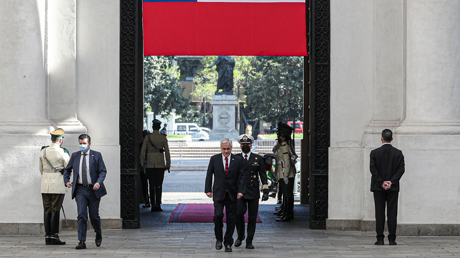 Chilean President Sebastian Pinera arrives at La Moneda presidential palace one day after a referendum in which people voted in favor of rewriting the nation's constitution in Santiago, Chile, Monday, Oct. 26, 2020. Amid a year of contagion and turmoil, Chileans turned out Sunday to vote overwhelmingly in favor of having a constitutional convention draft a new charter to replace guiding principles imposed four decades ago under the military dictatorship of Gen. Augusto Pinochet. (AP Photo/Esteban Felix)