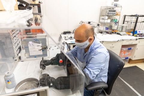 Mechanical engineer Emrah Celik prepares feedstock material for the 3D printing process of a lightweight, yet strong, thermoset composite.