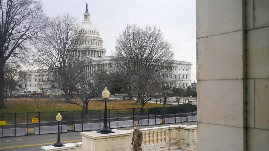 With the U.S. Capitol Building in view, a member of the military stands guard outside Russell Senate Office Building on Capitol Hill in Washington, Friday, Jan. 8, 2021, in response to supporters of President Donald Trump who stormed the Capitol. (AP Photo/Patrick Semansky)