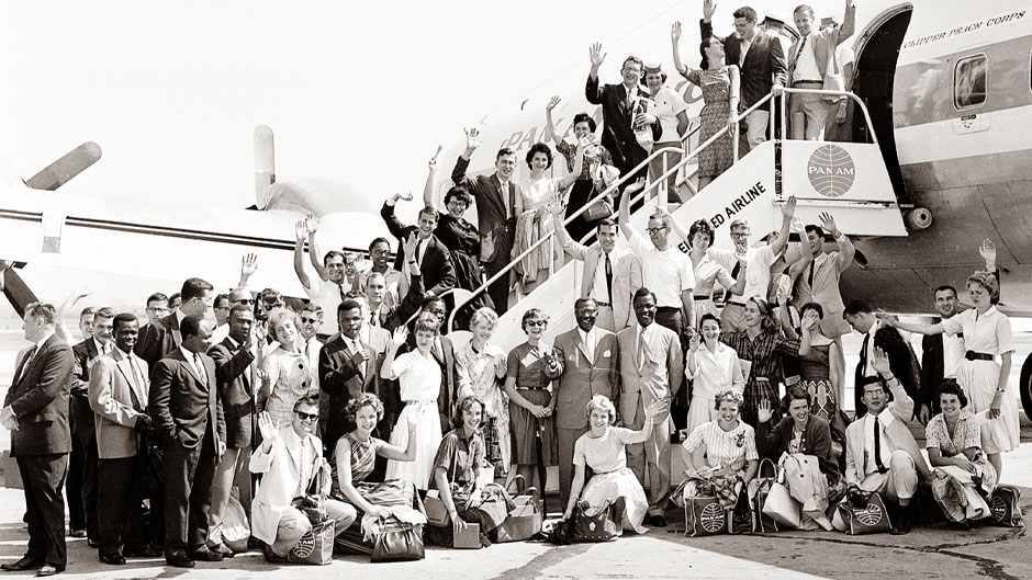 First members of the Peace Corps Volunteers to leave for overseas duty wave from the ramp of their plane at National Airport, MATS Terminal, Washington, D.C., Aug. 29, 1961. They will travel to Ghana, Africa, for teaching assignments. (AP Photo)
