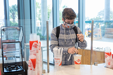 A student orders a smoothie on campus.