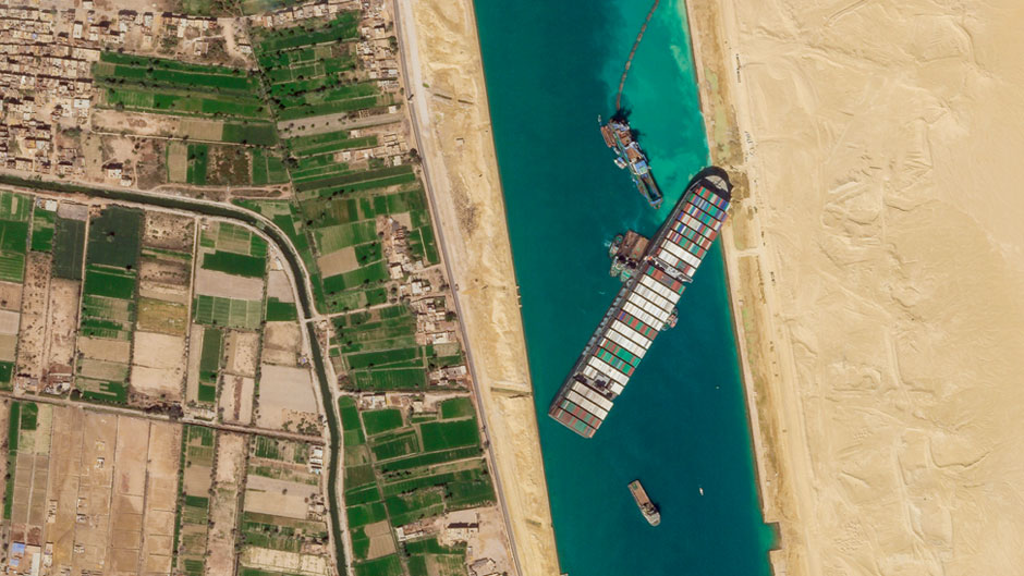 FILE - In this March 28, 2021, satellite file image from Planet Labs Inc, the cargo ship MV Ever Given sits stuck in the Suez Canal near Suez, Egypt. Consumers may face shortages and higher prices for electronics, toys, furniture and other goods should attempts to free the mammoth container ship stuck in Egypt’s Suez Canal drag on several weeks. (Planet Labs Inc. via AP)