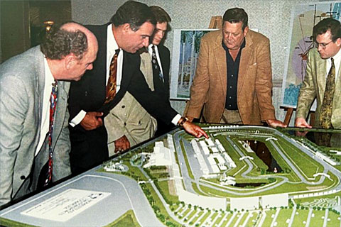 Sanchez and partners look at a model of the Homestead-Miami Speedway