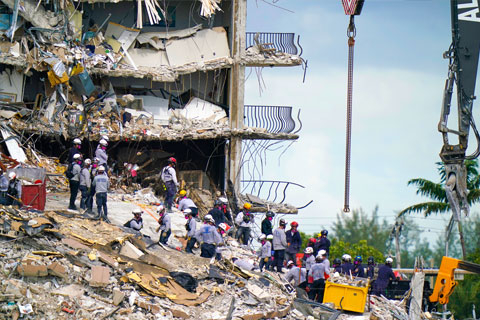 Rescue workers search in the rubble at the Champlain Towers South condominium, Monday, June 28, 2021, in the Surfside area of Miami. Many people are still unaccounted for after the building partially collapsed last Thursday. (AP Photo/Lynne Sladky)