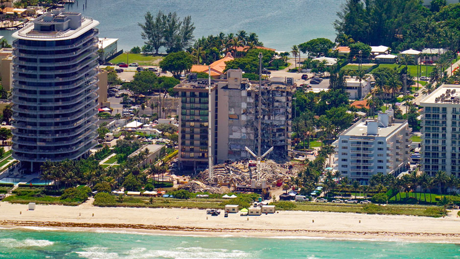 This aerial image shows an oceanfront condo building that partially collapsed three days earlier, resulting in fatalities and many people still unaccounted for, in Surfside, Fla., Sunday, June 27, 2021. (AP Photo/Gerald Herbert)