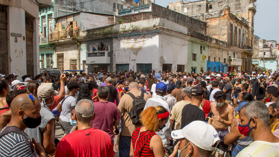 Anti-government protesters march in Havana, Cuba, Sunday, July 11, 2021. Hundreds of demonstrators went out to the streets in several cities in Cuba to protest against ongoing food shortages and high prices of foodstuffs. (AP Photo/Ismael Francisco)