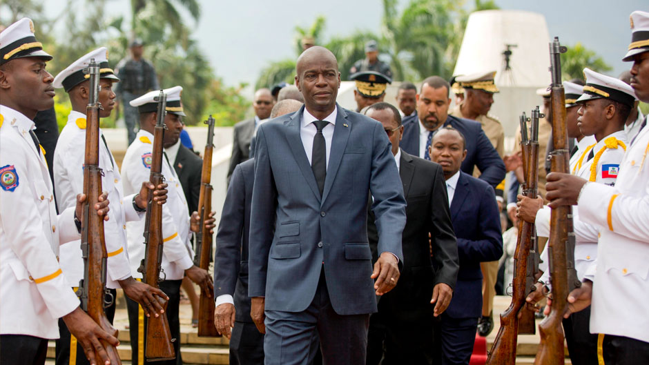 In this April 7, 2018, file photo, Haiti's President Jovenel Moise, center, leaves the museum during a ceremony marking the 215th anniversary of revolutionary hero Toussaint Louverture's death, at the National Pantheon museum in Port-au-Prince, Haiti. Moïse was assassinated after a group of unidentified people attacked his private residence, the country’s interim prime minister said in a statement Wednesday, July 7, 2021. (AP Photo/Dieu Nalio Chery, File)