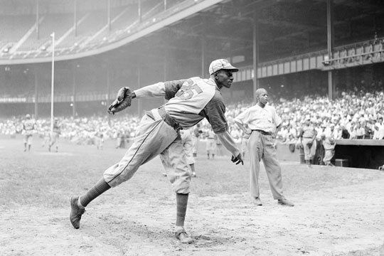 In this Aug. 2, 1942, file photo, Kansas City Monarchs pitcher Leroy Satchel Paige warms up at New York's Yankee Stadium before a Negro League game between the Monarchs and the New York Cuban Stars.
