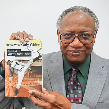 Donald Spivey photographed with his book, "If You Were Only White: The Life of Leroy 'Satchel' Paige"