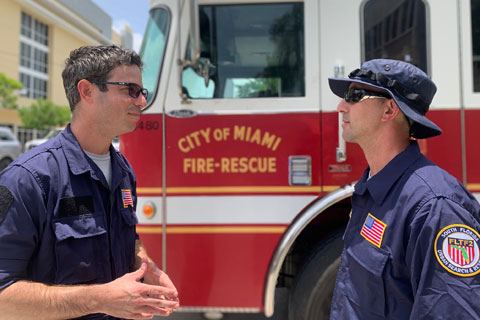 South Florida Urban Search and Rescue/Task Force 2 team members, from left, Brandon Parker, a surgical critical care physician at the Miller School of Medicine, and Ahmed Abousaleh, medical coordinator for Task Force 2, at Friday's homecoming event.