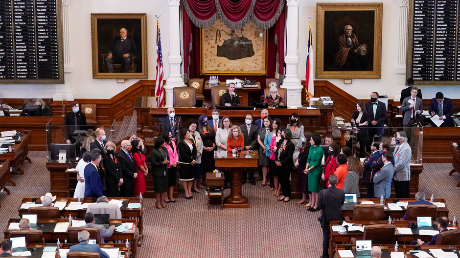 In this May 5, 2021, file photo, Texas state Rep. Donna Howard, D-Austin, center at lectern, stands with fellow lawmakers in the House Chamber in Austin, Texas, as she opposes a bill introduced that would ban abortions as early as six weeks and allow private citizens to enforce it through civil lawsuits, under a measure given preliminary approval by the Republican-dominated House. A Texas law banning most abortions in the state took effect at midnight on Sept. 1. (AP Photo/Eric Gay, File)