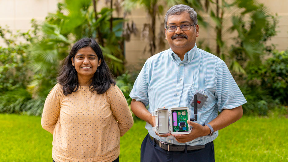 Doctoral student Shruti Choudhary, left, and Pratim Biswas, dean of the College of Engineering. Biswas holds a MAXIMA air quality sensor. Photo: TJ Lievonen/University of Miami