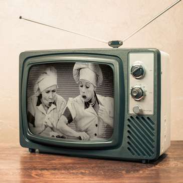 A still of "I Love Lucy" on an old-fashioned television set.
