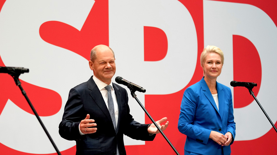 Olaf Scholz, left, top candidate for chancellor of the Social Democratic Party (SPD), and Manuela Schwesig, right, member of the SPD and governor of the German state of Mecklenburg-Western Pomerania, arrive fo a press statement at the party's headquarter in Berlin, Germany, Monday, Sept. 27, 2021. The center-left Social Democrats have won the biggest share of the vote in Germany's national election. They narrowly beat outgoing Chancellor Angela Merkel's center-right Union bloc in a closely fought race that will determine who succeeds the long-time leader at the helm of Europe's biggest economy. (AP Photo/Michael Sohn)