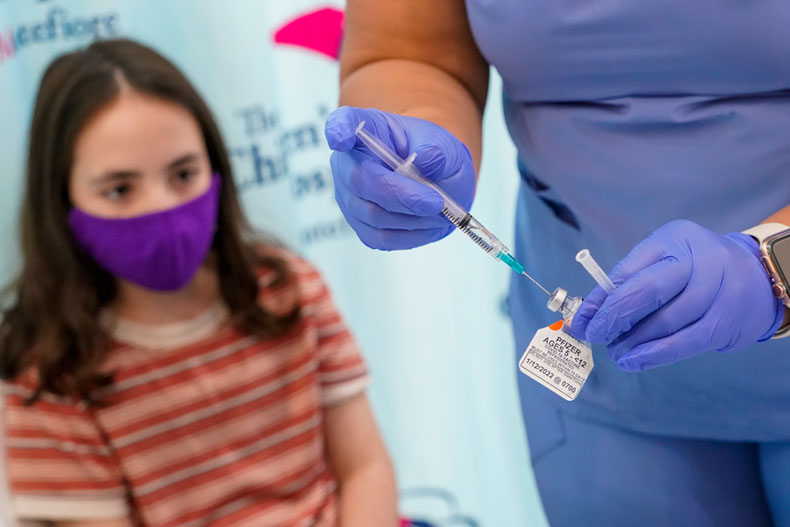 Jamie Onofrio Franceschini, 11, watches as RN Rosemary Lantigua prepares a syringe with her first dose of the Pfizer COVID-19 vaccine for children five to 12 years at The Children's Hospital at Montefiore, Nov. 3, 2021, in the Bronx borough of New York. (AP Photo/Mary Altaffer, File)