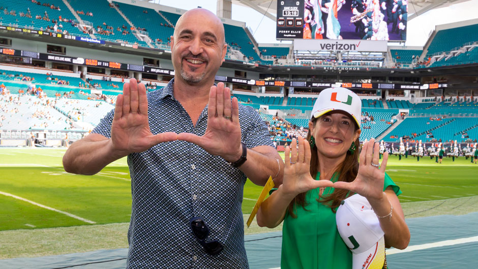 Andy Unanue and wife on football sidelines