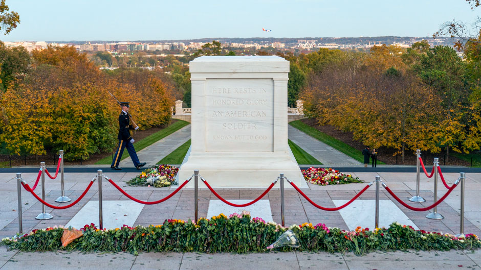 A tomb guard of the 3rd U.S. Infantry Regiment, known as "The Old Guard," walks at the end of the first day of a centennial commemoration event at the Tomb of the Unknown Soldier, in Arlington National Cemetery, Tuesday, Nov. 9, 2021, in Arlington, Va. (AP Photo/Alex Brandon, Pool)